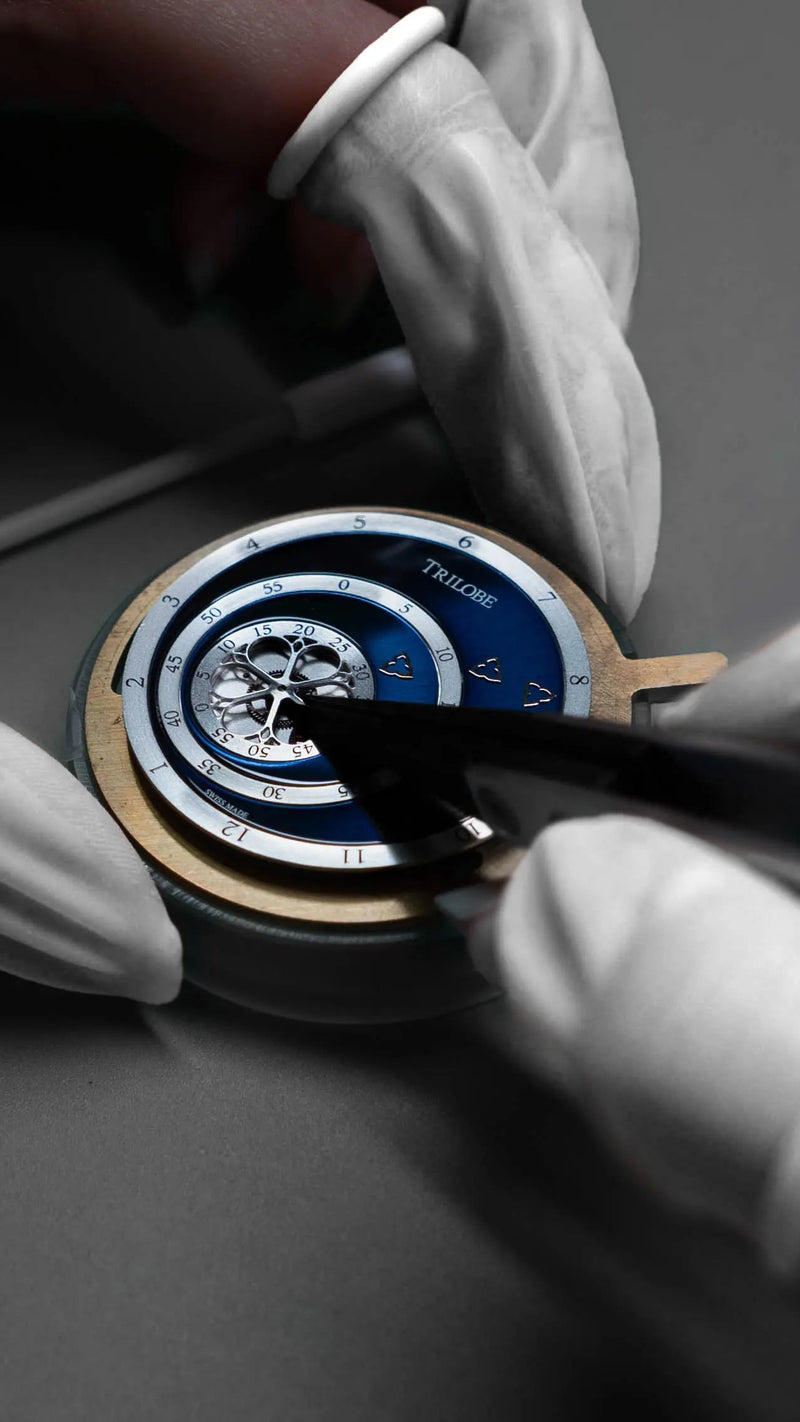 trilobe les matinaux watch being assembled by a watchmaker