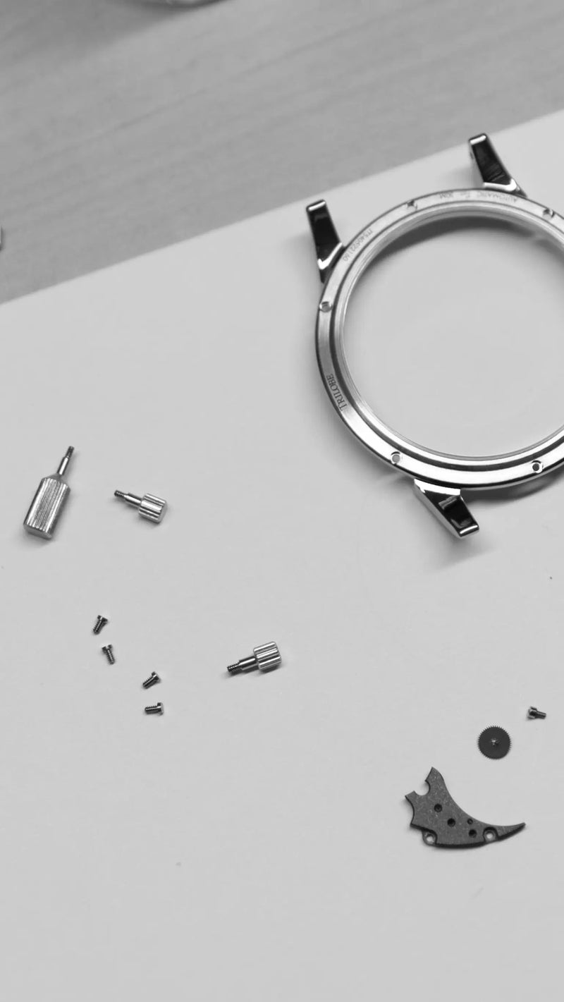 trilobe watch components and case parts during assembly